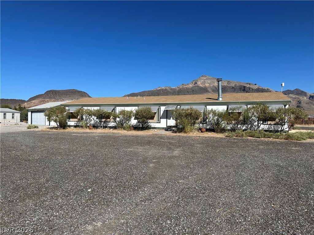 3270 West Simkins Road Pahrump, NV 89060 - Photo 1 of 36 Rugged mountain peaks form a dramatic backdrop for this single-level desert home.