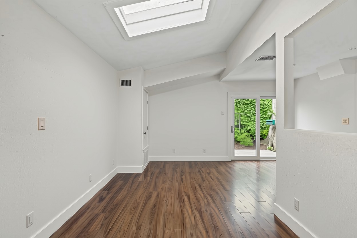 3302 Cherrywood Road Austin, TX 78722 - Photo 12 of 34 a view of an empty room with wooden floor and a window