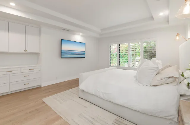a bathroom with a double vanity sink window and mirror