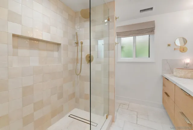 a bedroom with a bed and large windows