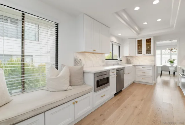 a kitchen with a sink cabinets and window