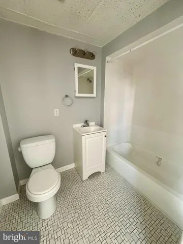 a bathroom with a toilet sink and bathtub