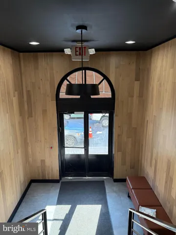 a kitchen with a sink a stove cabinets and a wooden floor