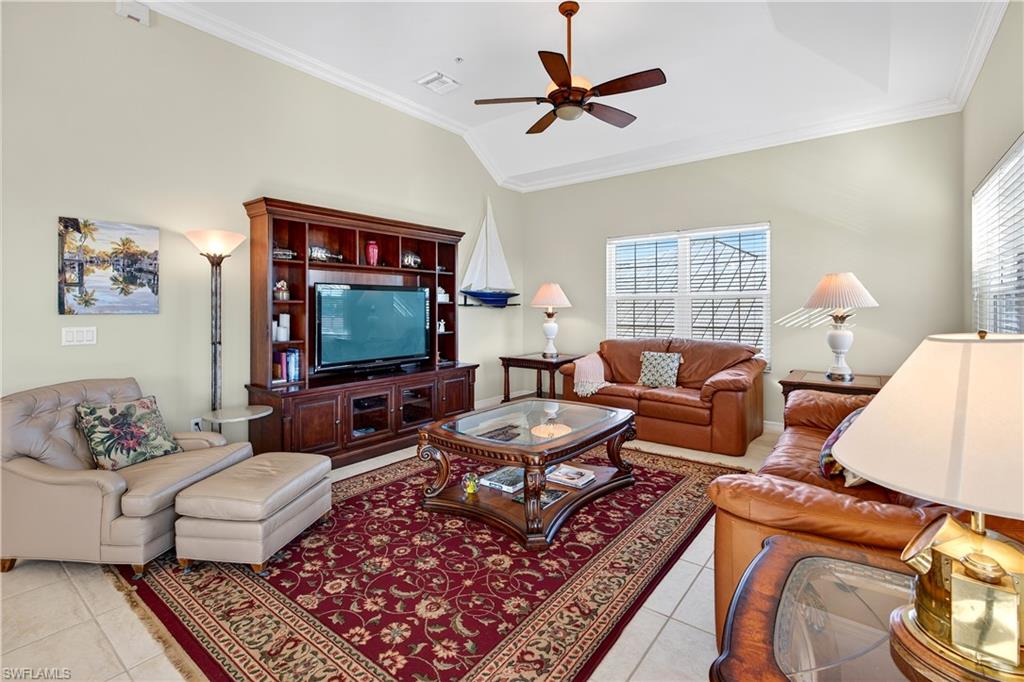 322 Angler Drive, Unit 502 Goodland, FL 34140 - Photo 11 of 38 Living area with ornamental molding, healthy amount of natural light, vaulted ceiling, light tile patterned floors, and ceiling fan