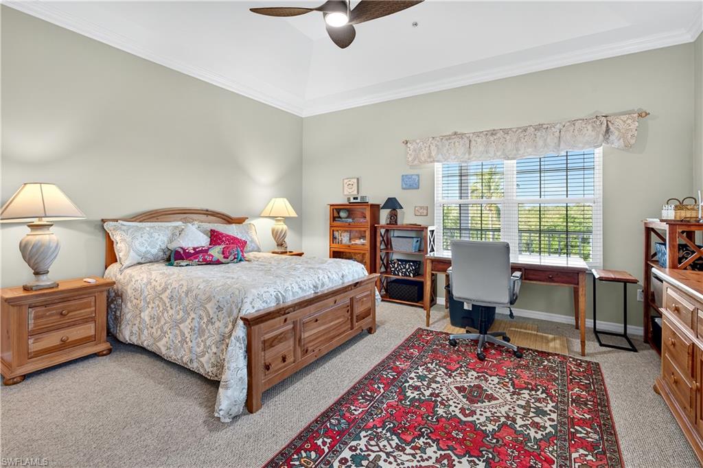 322 Angler Drive, Unit 502 Goodland, FL 34140 - Photo 17 of 38 Bedroom featuring light colored carpet, ornamental molding, ceiling fan, and an office area