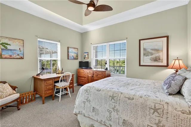 a bedroom with a bed and a dresser next to a window