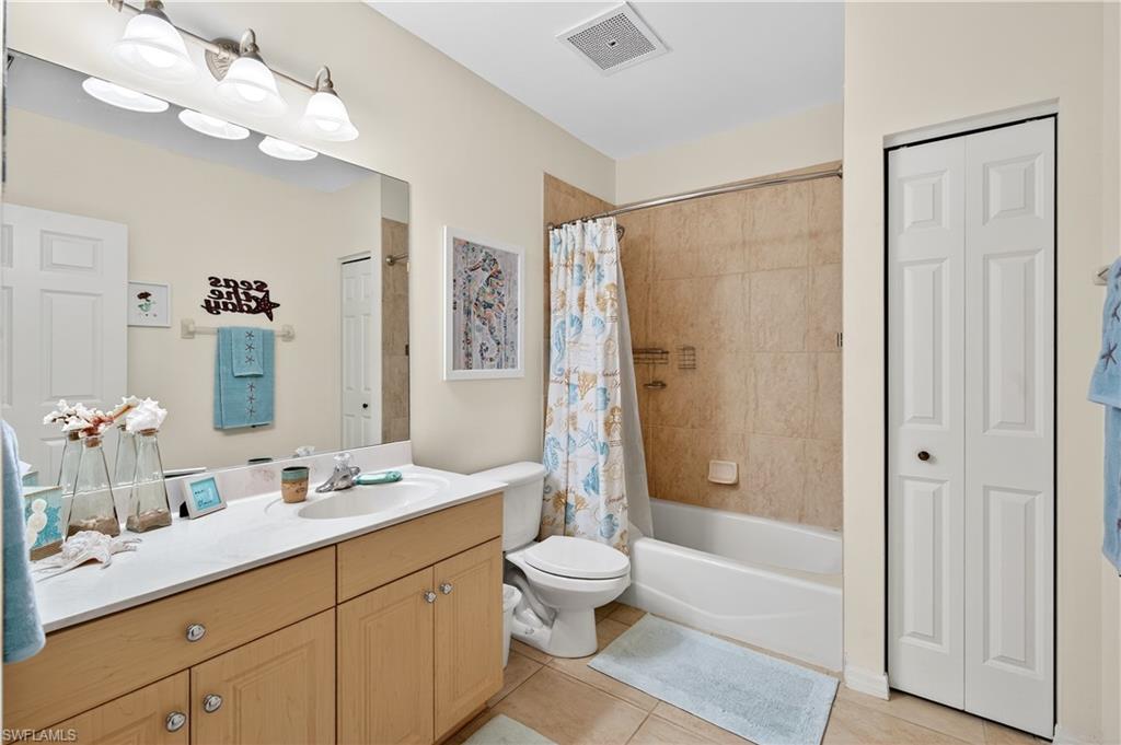 322 Angler Drive, Unit 502 Goodland, FL 34140 - Photo 23 of 38 Bathroom featuring a shower / bath combo, vanity, and light tile patterned floors