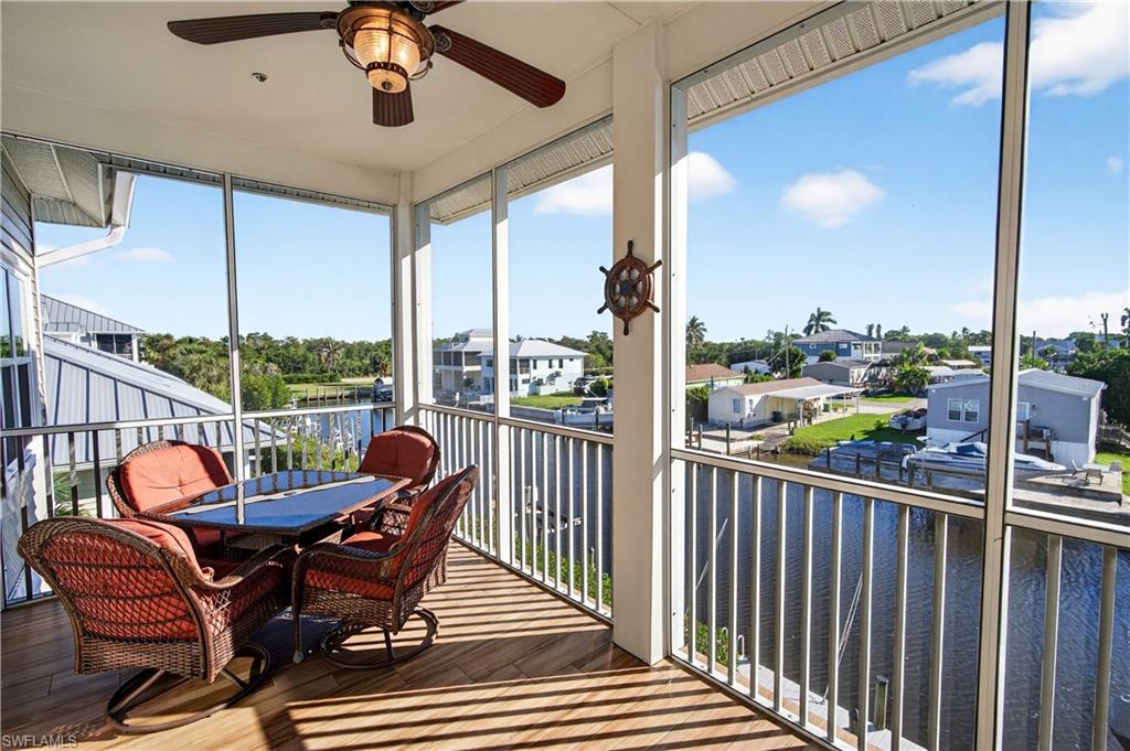 322 Angler Drive, Unit 502 Goodland, FL 34140 - Photo 25 of 38 Screened in lanai with water view, and ceiling fan