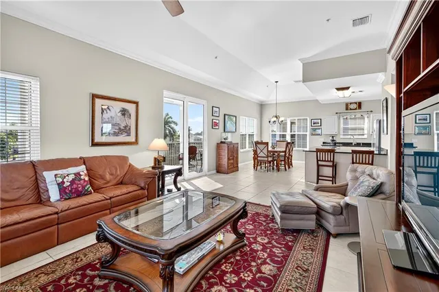 a living room with furniture a rug and a window