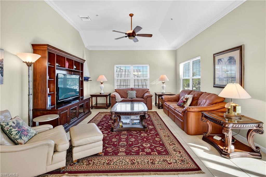 322 Angler Drive, Unit 502 Goodland, FL 34140 - Photo 10 of 38 Living area with crown molding, light tile patterned floors, and a ceiling fan