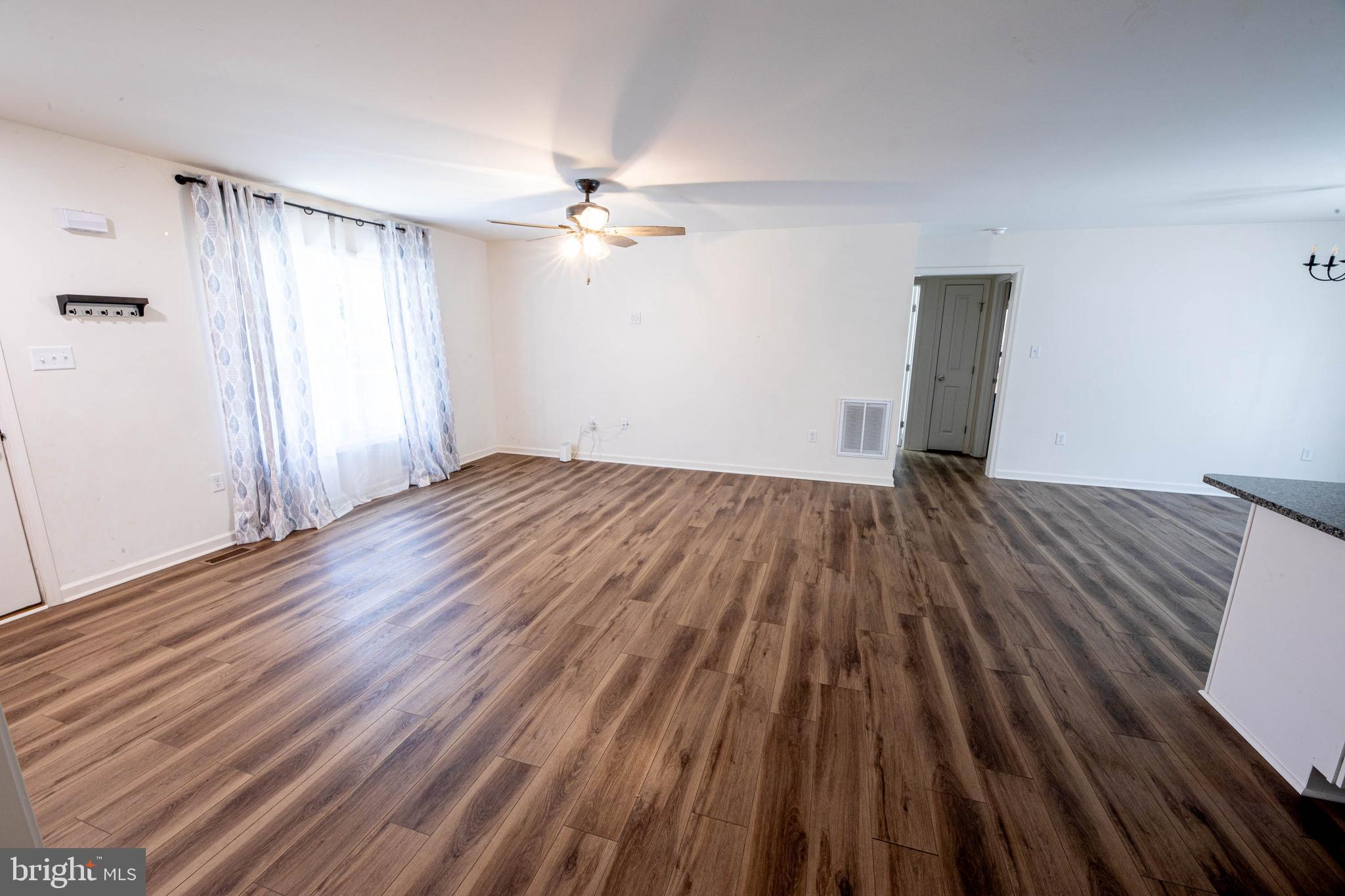 26300 Fire Tower Road Seaford, DE 19973 - Photo 5 of 52 a view of empty room with wooden floor and fan