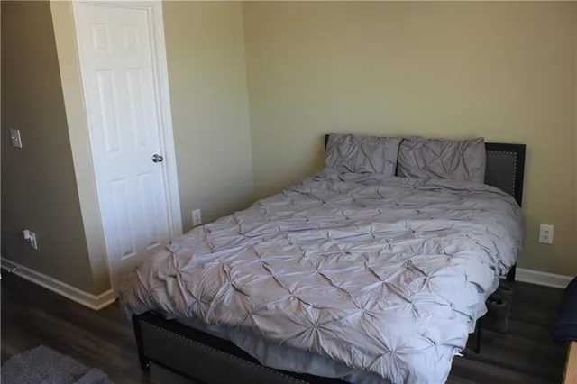 a bed sitting in a bedroom next to a window