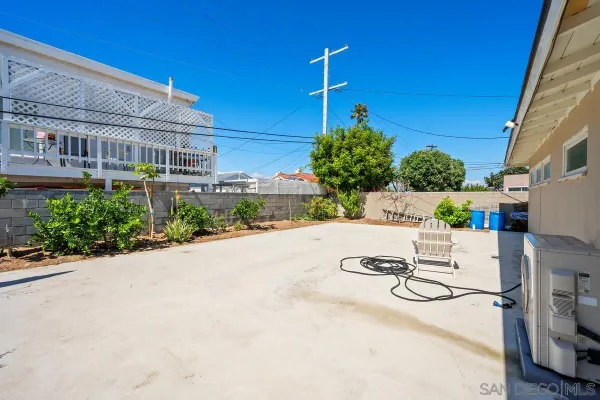 a view of a patio with a table and chairs and potted plants