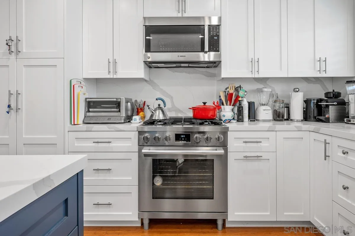 231 Sunridge Street Playa del Rey, CA 90293 - Photo 5 of 28 a kitchen with granite countertop white cabinets and stainless steel appliances