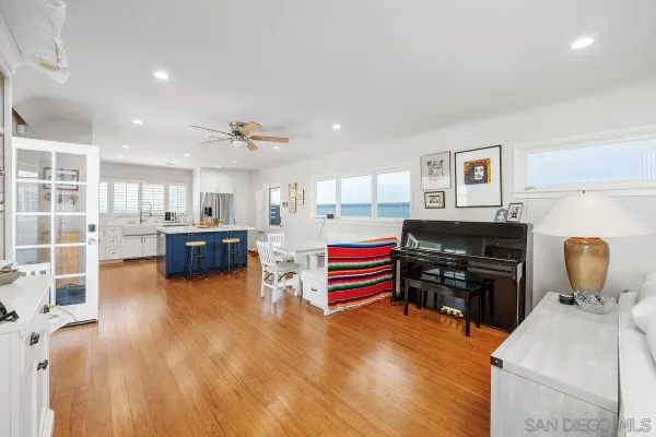 a living room with furniture and kitchen view