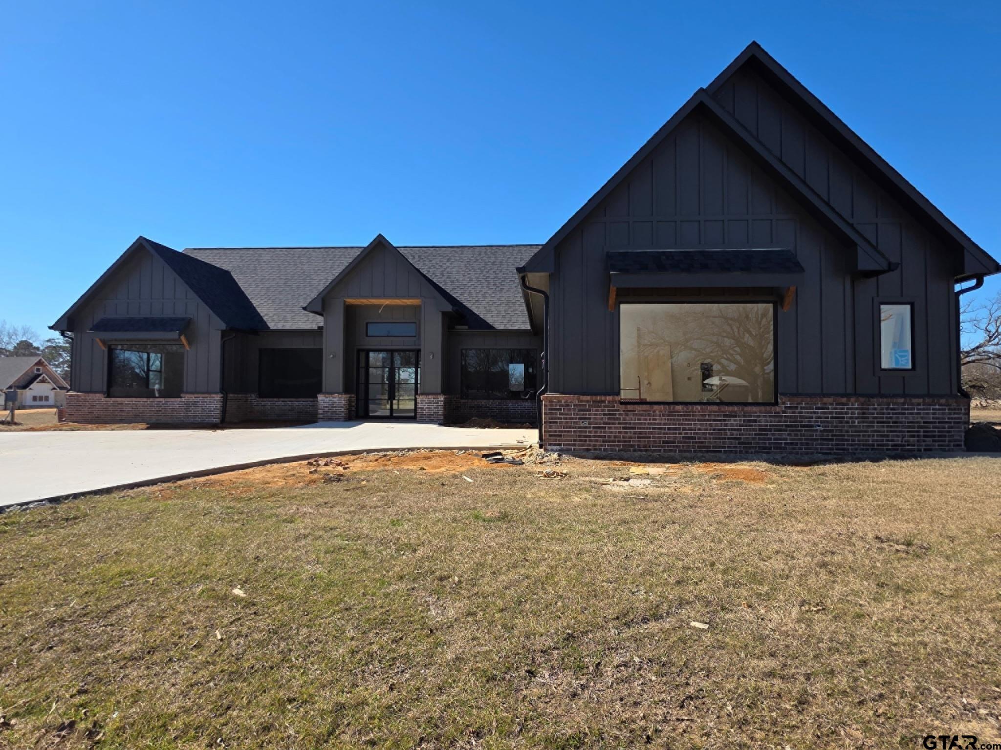 2713 Tbd Private Road Mount Pleasant, TX 75455 - Photo 2 of 15 a front view of a house with a yard and garage
