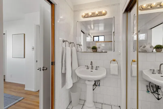 a bathroom with a sink a mirror and shower