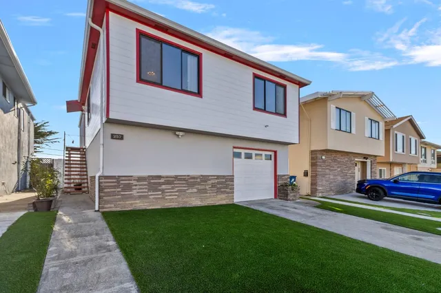 a front view of a house with a yard