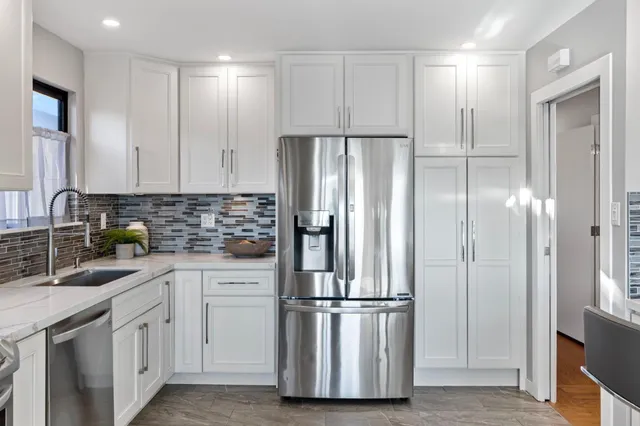 a kitchen with cabinets and stainless steel appliances