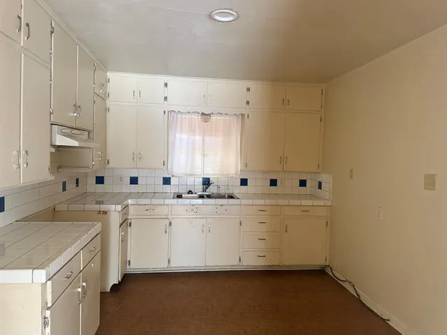 a view of a kitchen with cabinets