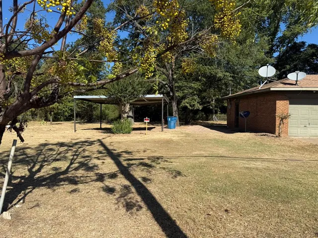 a view of a yard covered with snow in front of house