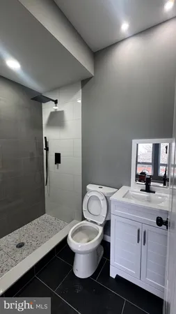 a bathroom with a toilet and a shower