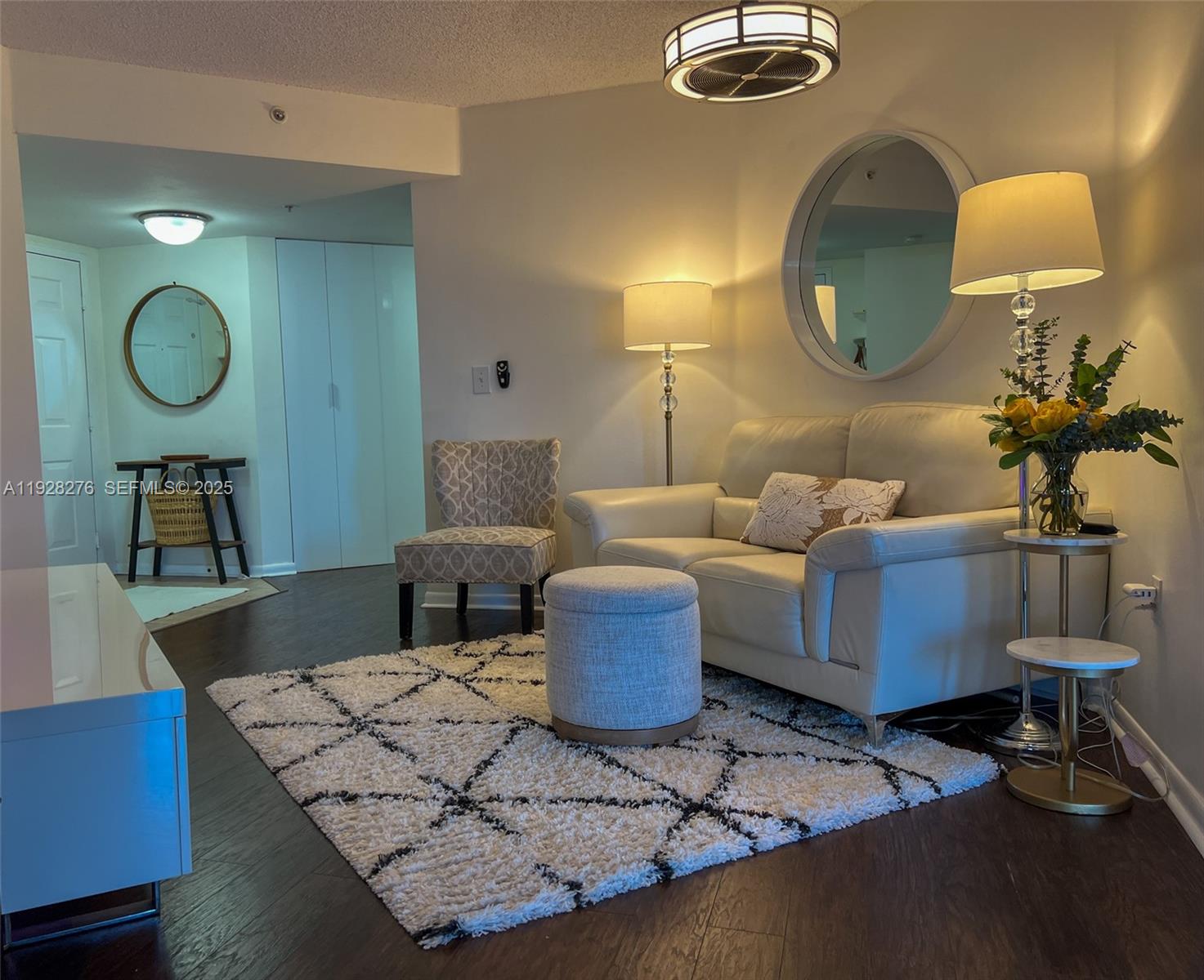a living room with furniture and a mirror