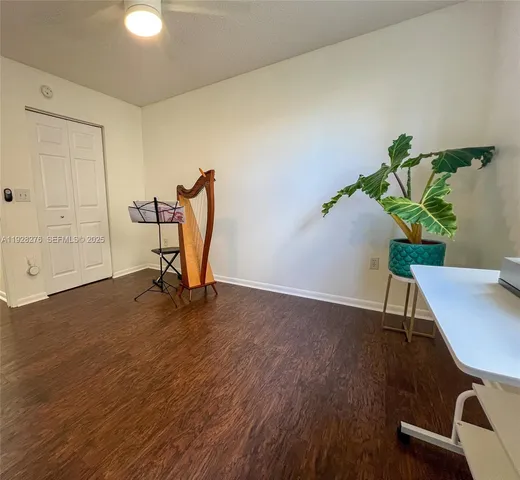 a view of a workspace with furniture and a potted plant