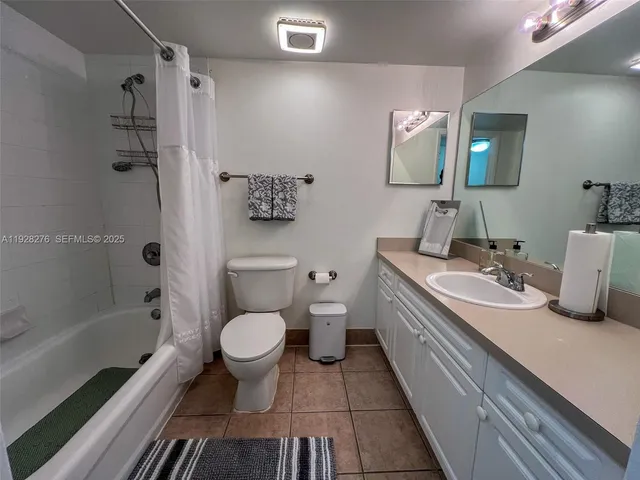 a bathroom with a double vanity sink toilet and shower