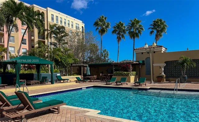 a swimming pool with outdoor seating and yard