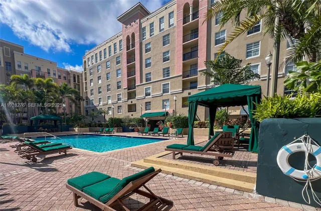 a view of a building with sitting area and garden