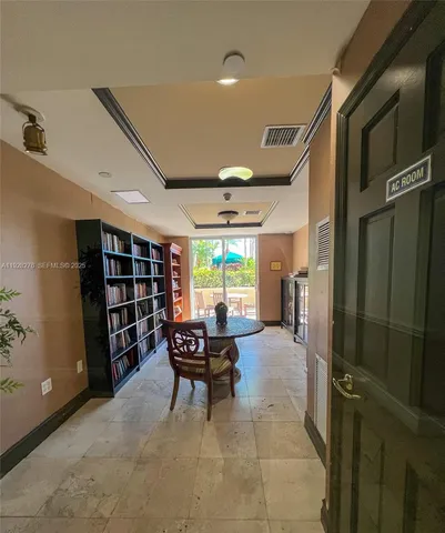 a room with pool table and windows