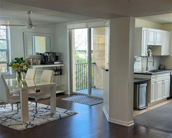 a kitchen with counter top space and wooden floor