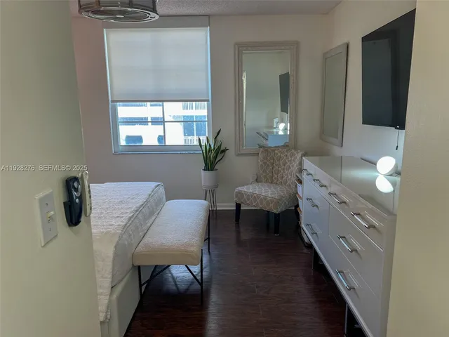 a bedroom with a bed and a dresser in it