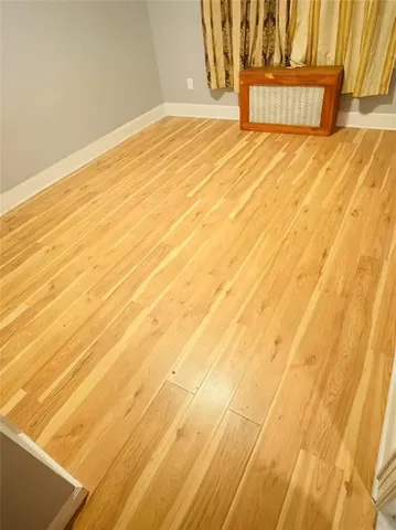 a view of a room with wooden floor and white walls
