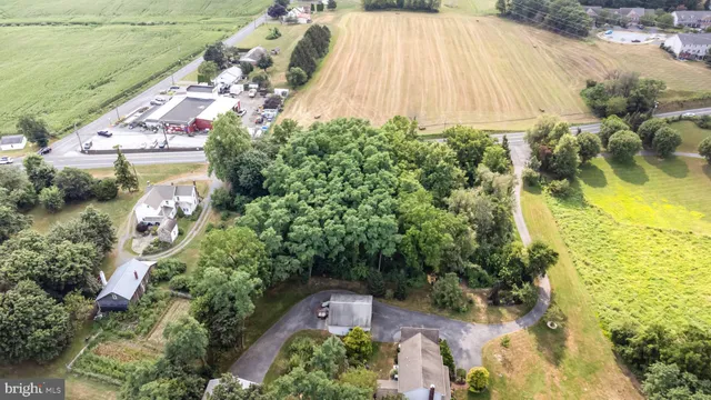 an aerial view of a residential houses with yard