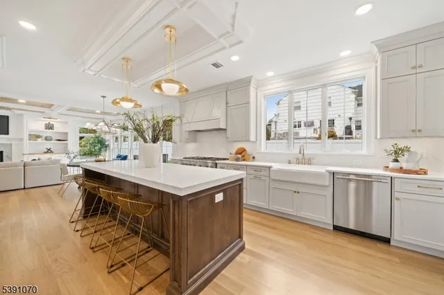 a kitchen with a stove a sink dishwasher and a refrigerator