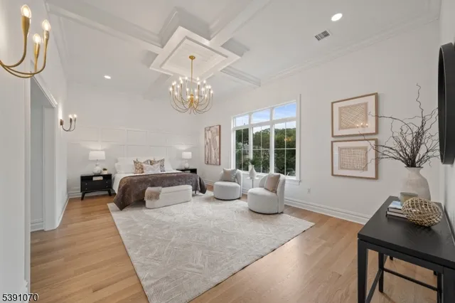 a bedroom with furniture and a large window