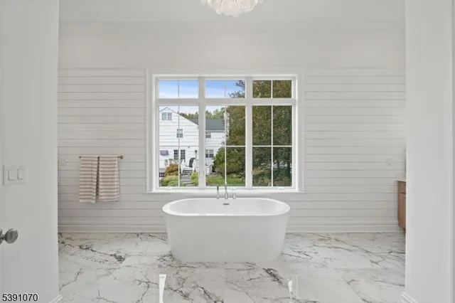 a bathroom with a bathtub and a window