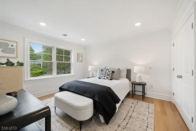a bedroom with a large bed and a window
