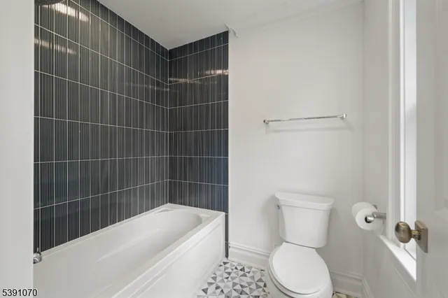 a bathroom with a bathtub a toilet and a shower