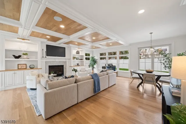 a living room with furniture a fireplace and a table