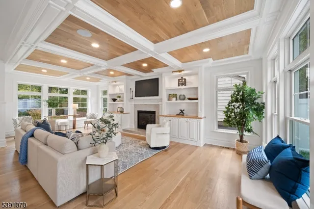a living room with fireplace furniture and a large window