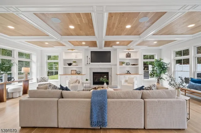 a living room with fireplace furniture and a large window
