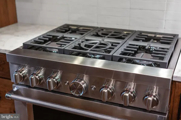 a stove top oven sitting inside of a kitchen