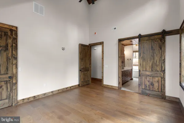 an empty room with windows and closet