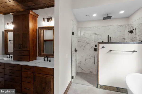 a bathroom with a double vanity sink mirror and next to a window