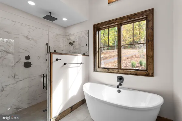 a white bath tub sitting next to a window