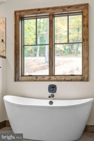 a bathroom with a double vanity sink toilet mirror and bathtub