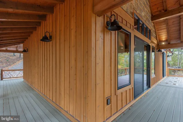 a view of a porch with wooden floor and outdoor space